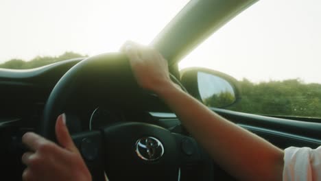 Girl-driving-Toyota-car-in-sunny-weather