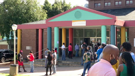 African-people-standing-in-line-at-government-building,-panning-shot-left-to-right-at-Randburg-Johannesburg