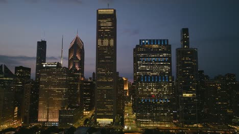 High-rise-with-night-lights-in-the-New-Eastside-of-Chicago,-USA---Aerial-view