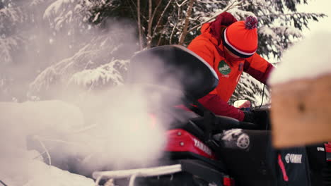 Starting-up-a-red-Yamaha-Snowmobile-on-a-winter-morning-in-Sweden