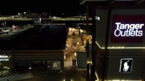 Tanger-Outlets-mall-sign-at-Canadian-outdoor-mall-in-winter-season-with-Christmas-lights-set-up-at-night-time