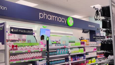 a-pharmacy-counter-with-shelves-stocked-up-with-medication