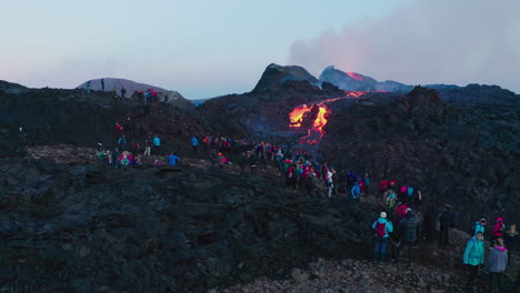 Crowd-of-people-watching-lava-flow-from-the-volcanic-eruption-in-Geldingadalir-in-Reykjavik,-Iceland