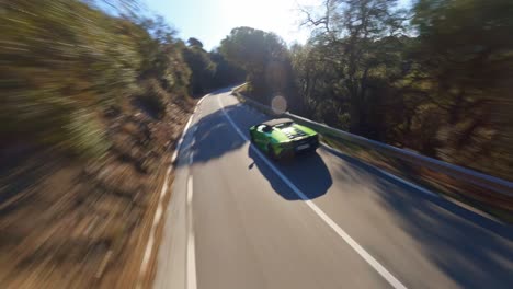 Antena-FPV-Siguiendo-Un-Lamborghini-Conduciendo-Por-Una-Pintoresca-Carretera-De-Montaña-En-España