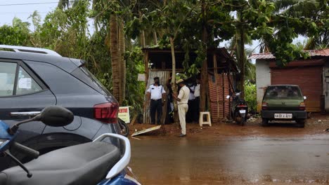 Indian-Police-Officers-Stand-Outside-Roadside-Station-Shack-Outpost-on-Windy-Day