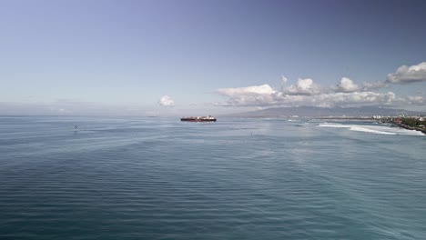 Aerial-view-of-cargo-ship-departing-Oahu-on-calm-sunny-day