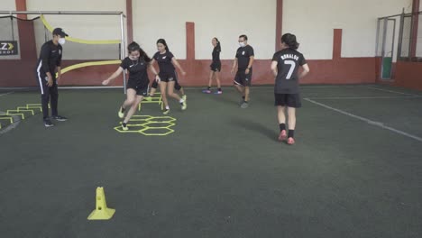 A-football-player-on-a-hexagonal-speed-and-agility-training-ladder-rings-in-the-field