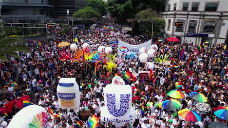 Large-crowd-holding-rainbow-flags-and-sheets-in-the-Pride-celebrations-in-Mexico-city---Aerial-view