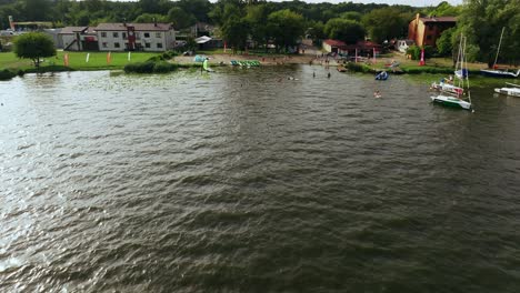 Aerial-View-of-Windsurfer-in-Zagrza-Lake,-Poland-on-Sunny-Summer-Evening,-Drone-Shot