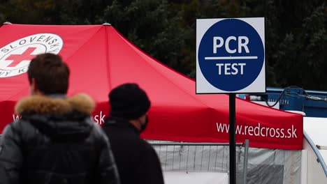 Close-up-slow-motion-shot-Covid-19-Coronavirus-testing-centre-and-people-queuing