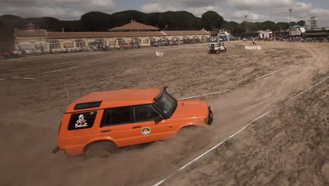 FPV-action:-Orange-Land-Rover-bogs-down-in-deep-sand-ruts-in-race