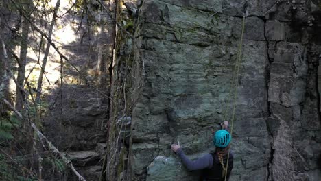 Rock-Climbing-At-Whitefish,-Montana---Female-Rock-Climber-On-Harness-Climbing-On-Rocky-Escarpment