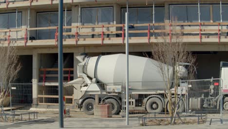 Truck-Helper-Guiding-Concrete-Mixer-Truck-As-It-Drives-In-Reverse-At-The-Construction-Site-In-Vienna,-Austria