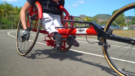 SAN-RAMON,-COSTA-RICA---MARCH-19,-2022:-a-kid-with-disability-driving-a-handbike-at-a-paracycling-race