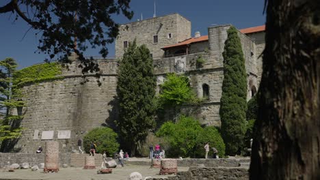 External-view-of-a-castle,-with-people-outside