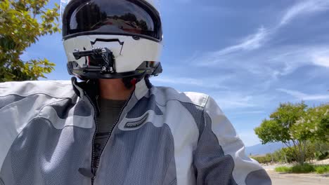 Rider-on-motorbike-driving-on-highway-on-sunny-day