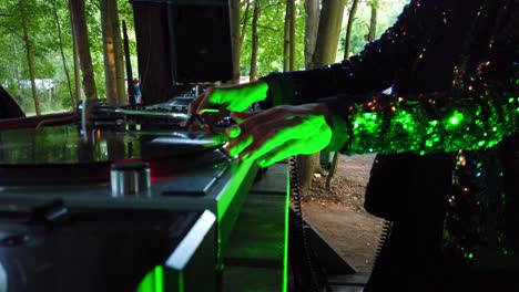 Nahaufnahme,-Plattenspieler,-Plattennadel,-Mischpult-Und-Hände-Einer-DJane-Bei-Der-Arbeit-Auf-Einem-Musikfestival,-Rote-Dichte-Im-Wald,-Spielen-Techno