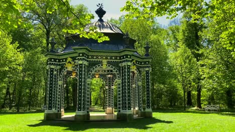 The-green-pleasure-house-in-Laxenburg-Palace-Park,-shot-on-a-warm-day-in-spring,-truck-shot,-side-movement