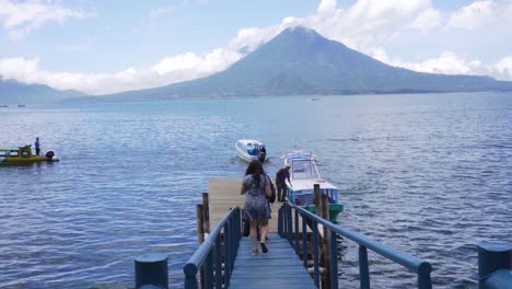 visitors-walk-towards-Lake-Atitlan-Dock-in-santa-cruz-la-lagoon,-solola,-Guatemala-on-August-2,-2022