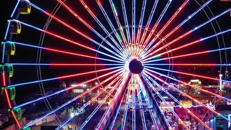 An-aerial-view-starting-at-the-center-of-the-colorful-ferris-wheel-in-Santa's-Enchanted-Forest