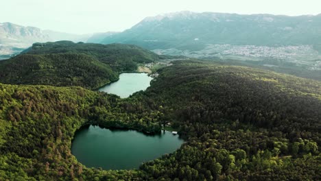 Forest-surrounded-lakes-in-the-Italian-Alps-with-nearby-villages