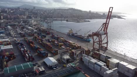 Aerial-view-of-Vigo-terminal-port-during-lockdown-with-cargo-ship,-containers-and-the-harbor-cranes-in-sunset