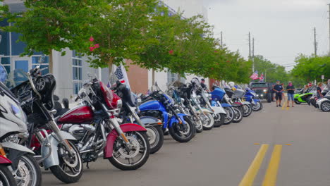 Motorcycles-parked-on-street-at-motorbike-rally-with-American-flags