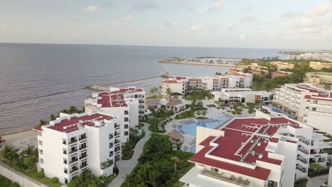 AERIAL---A-hotel-and-its-swimming-pools-in-Cancun,-Mexico,-circle-pan