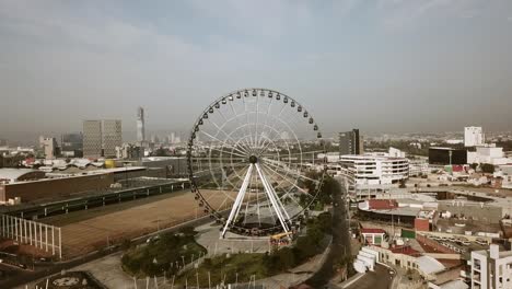 Front-side-of-the-Ferris-showing-Angelopolis-mall,-part-of-the-city-and-the-small-malls