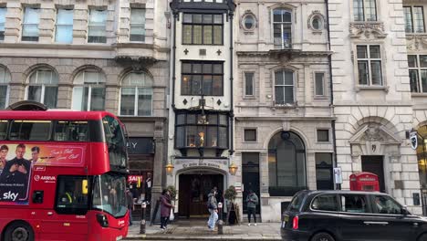 Tilting-down-from-rooftop-to-streets-of-London-with-bus-and-people