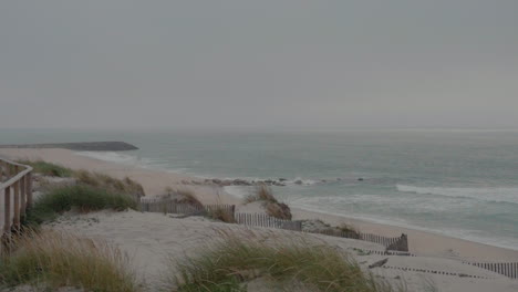 Coastal-view-of-Praia-da-Costa-Nova-in-Aveiro,-Portugal,-featuring-sand-dunes,-beach-grass,-and-ocean-waves