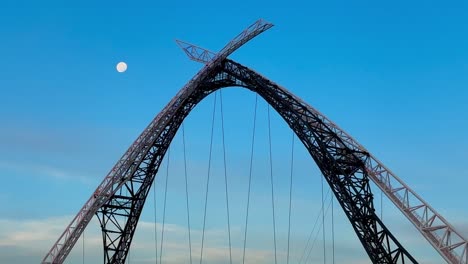 Moon-and-Matagarup-Bridge,-Perth,-Western-Australia-with-blue-sky