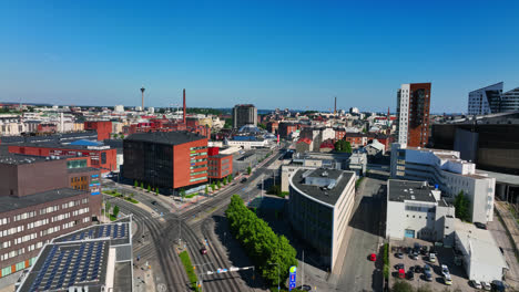 Aerial-tracking-shot-overlooking-the-Ratina-district,-summer-in-Tampere,-Finland