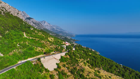 Drone-following-a-coastal-road-on-the-Makarska-riviera-summer-day-in-Croatia