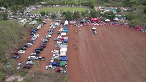 Drone-view-of-Horse-racing-on-dusty-ground,-Costa-Rica