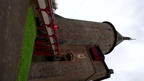 Lone-woman-walking-over-a-bridge,-leaving-Castell-Coch-behind-her-in-Wales