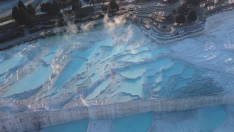 Steamy-blue-water-hot-springs,-mineral-waters,-forming-travertine-limestone-mineral-deposit-formations