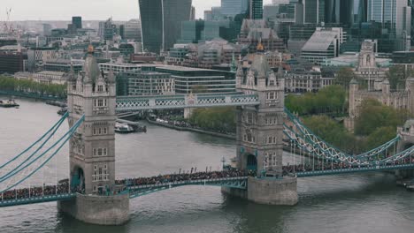 Slow-Retreat-Shot-of-Marathon-on-Tower-Bridge-with-City-Views