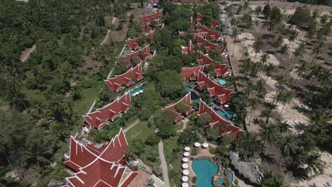 drone-dolly-shot-of-two-resorts-on-the-Island-of-Koh-Chang-with-beach-ocean-river-and-paddle-boards