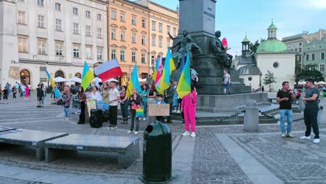 Demonstration-to-support-peace-in-Ukraine-on-Rynek-Glowny-Street,-Adam-Mickiewicz-Monument-at-Main-Market-Square