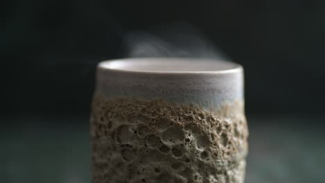 Close-up-of-a-little-of-rising-smoke-over-a-ceramic-glass