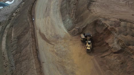 Orbit-Shot-Of-Excavator-Filling-Up-Truck-In-Nickel-Mine-Site-In-Western-Australia