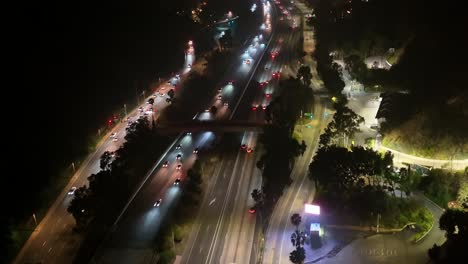 Cars-And-Trucks-Driving-On-A-Busy-Hollywood-Freeway-At-Night-In-Los-Angeles,-California