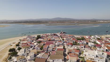 Aerial-view-of-Armona-Island,-Olhão,-Portugal,-featuring-a-coastal-village-and-serene-waterways