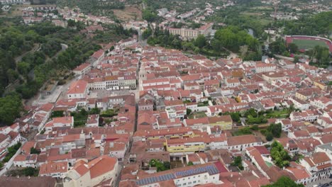 Aerial-orbit-medieval-old-town-in-city-Tomar-in-Portugal-on-a-cloudy-day