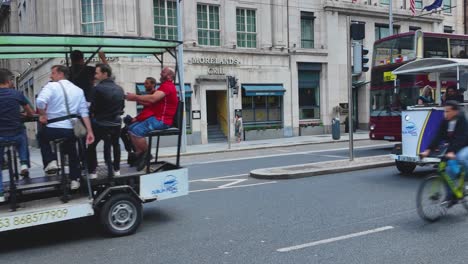 A-static-4K-shot-of-Two-pedal-powered-buses-or-trucks-on-a-Dublin-St