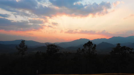 Breathtaking-aerial-flying-toward-the-sunset-in-a-scenic-mountain-landscape