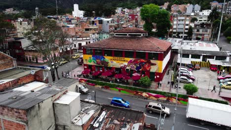 Drone-view-of-the-front-of-Plaza-de-Mercado-La-Perseverancia-in-Bogotá,-mural-and-mosaic-art-painted-by-a-group-of-artists-in-2017