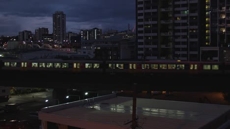 Under-canopy-of-midnight-velvet,-train-travels-through-quiet-darkness