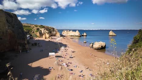 Hyperlapse-Sonniger-Sandstrand-In-Lagos,-Portugal-Mit-Menschen,-Die-Baden-Und-Sich-Sonnen